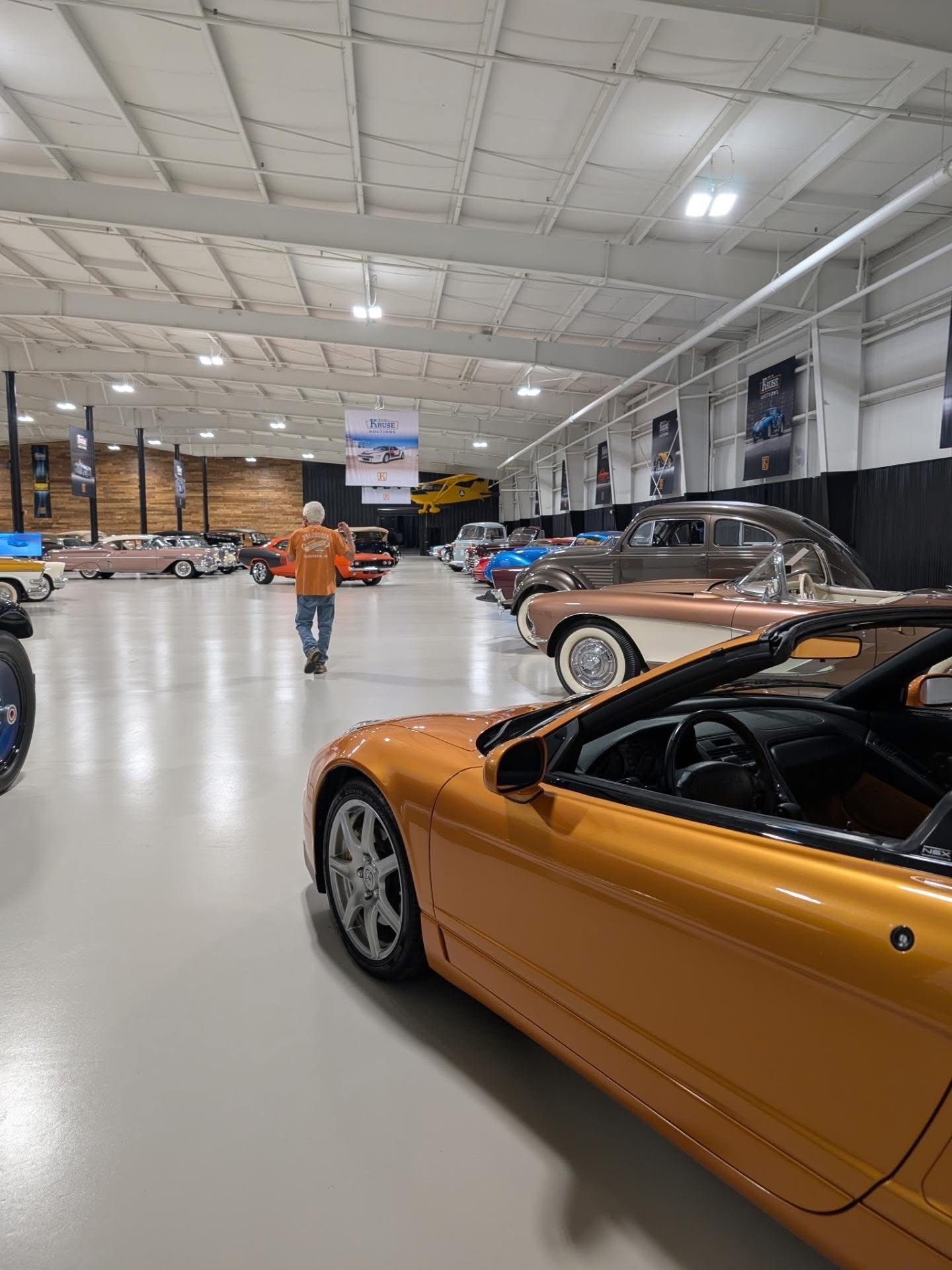 An Acura NSX leading a row of collector cars on the showroom floor