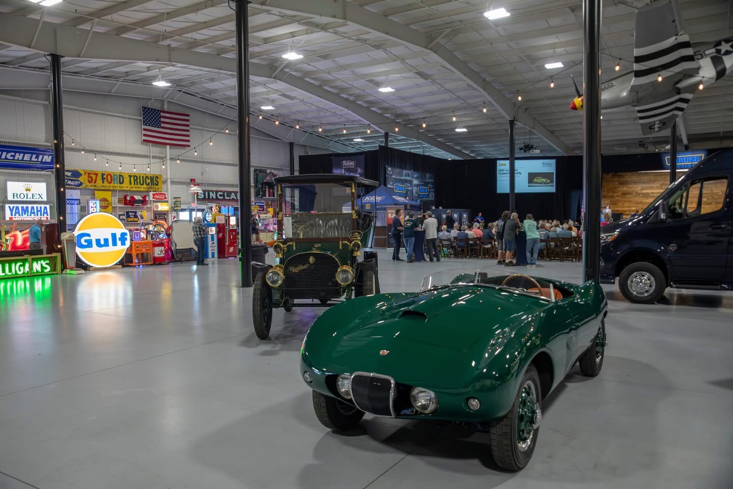 A green vintage roadster on the Auburn Classic Cars showroom floor