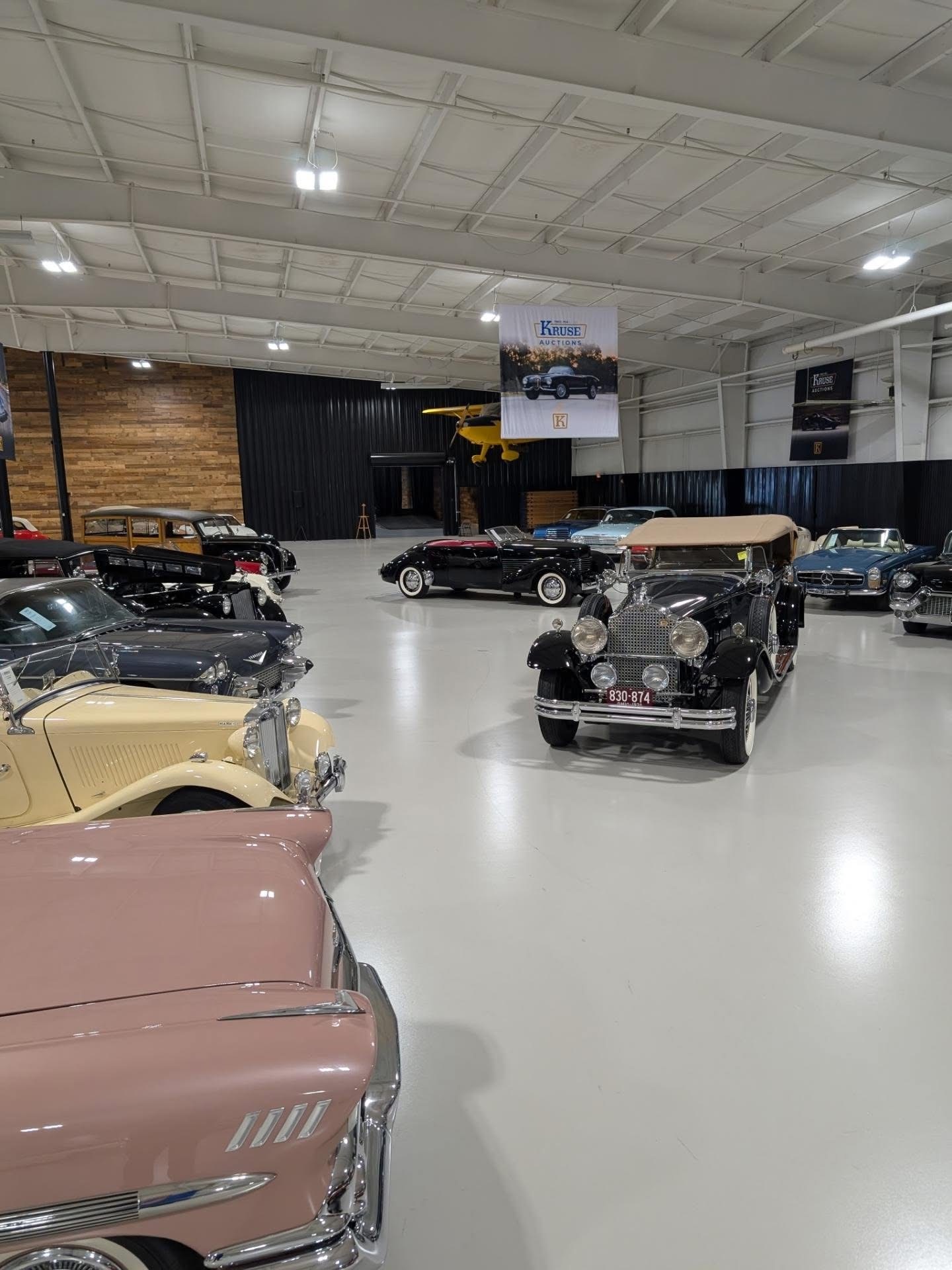 Rows of prewar classics beneath the Kruse Auctions banner